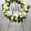 A beautiful white and green tribute wreath that calms, this easel arrangement