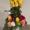 Delightful floral arrangement of yellow roses, variety of color of roses and