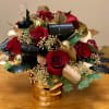 Gorgeous winter arrangement with red roses, tropical leaves, gold seeded eucalyptus, gold