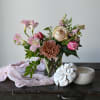 Our mason jar holds a simple, but lovely bouquet of seasonal flowers.