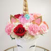 Pastel colored mixed florals with unicorn accessories in a ceramic vase.

 
The