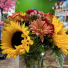 sunflowers, orange roses, red carnations, peach Berrys,  