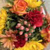 sunflowers, orange roses, red carnations, peach Berrys,  