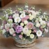 This delicate basket arrangement embodies the essence of softness and tranquility. Filled