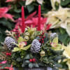 This elegant decorative centerpiece features a luxurious blend of natural and festive