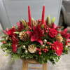 This stunning holiday arrangement is a vibrant celebration of the season, featuring