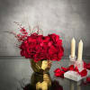 A lovely Gold Geometric vase holds this luscious arrangement of about 50