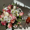 Beautiful light colors of crispy white roses and daisies mixed with cream