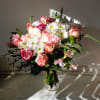 Beautiful light colors of crispy white roses and daisies mixed with cream