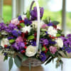 Elevate your gifting experience with our exquisite purple posies basket arrangement, bursting