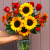 A sunny sunflower arrangement gets an autumnal spin with the addition of