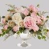 Illuminate love with embracing soft pastel shimmer and cradling an exquisite arrangement
