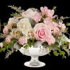 Illuminate love with embracing soft pastel shimmer and cradling an exquisite arrangement