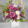 A playful spin on the classic rose arrangement, these lovely lavender blooms