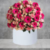 Red roses are beautifully arranged in a white cylinder box. Have them