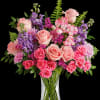 Soft pink roses breathe life into this perfectly feminine arrangement. This charming