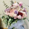 Beautiful pastel arrangement featuring lavender roses, white mums, lilies, carnations, and green