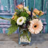 A sophisticated dreamy floral in muted hues of pale peach, celery green