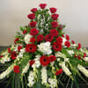 Brilliant red roses adorn the urn. A simple Beauty