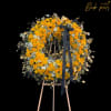 Both bright and abundant, this impressive standing wreath arrangement, carefully handcrafted by
