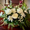 &ldquo;Winter&rsquo;s Nest&rdquo; is an elegant floral centerpiece nestled in an 8-inch wicker