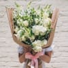 An assortment of beautiful white flowers includes Roses, snap dragons, lilies, hydrangeas-stock