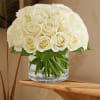 A refined and elegant arrangement of pure white roses, thoughtfully presented in