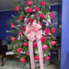 Standing arrangement with beautiful hot pink roses with lavender daisies and purple