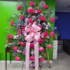 Standing arrangement with beautiful hot pink roses with lavender daisies and purple