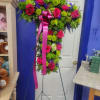 Large arrangement in the shape of cross. Includes hot pink roses, hot