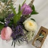A sweet mason jar filled with garden roses and accent flowers plus