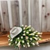  A serene and elegant casket spray designed to honor and celebrate