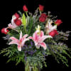 A charming bouquet of radiant red roses and delicate pink lilies, symbolizing