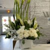 One of the best seller arrangement in whites Calla lilies, orchids, roses