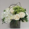 A beautiful fresh arrangement featuring hydrangea, roses and greenery below a halo