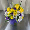 Mixed cut arrangement with yellow roses, yellow daisies, white alstroemeria, and purple