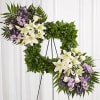 Standing spray arrangement features a stylized 18&quot; square wreath with assorted greenery