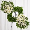 Standing spray arrangement features a stylized 18&quot; square wreath with assorted greenery