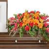 Bold and beautiful 1/2 casket spray.  Oranges and pinks perfectly meshed