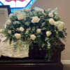Elegant white rose casket spray. Complete with white roses, white hydrangeas, queen