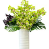 green cymbidium orchids and bright dayanthus adorned with anthurium leaves.
