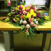 A wonderful display of pink and yellow flowers such as roses, snapdragons