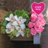 Ecuatorian roses and cymbidiums arranged in a wood box. 