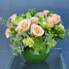 A darling arrangement with amazing taupe and peach roses in a leaf-lined