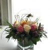 This glass cube will consist of 12 mixed colored roses. With designer