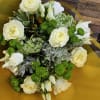 This graceful bouquet features a stunning combination of lush white roses, lisianthus