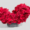 Large red roses in an asymmetrical heart-shaped arrangement.
