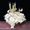 This artificial flower arrangement featuring white orchids and peonies,  It reflects