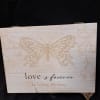 A wooden box with a quote and a butterfly 