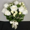 A gorgeous display of white roses with white spray roses, arranged in
